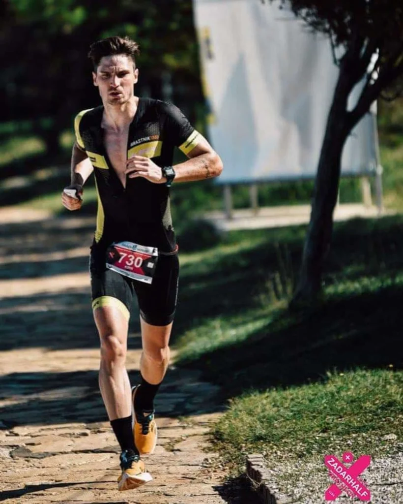 "Coach Primoz Kirn, showcasing determination and focus, competes fiercely during the Zadar Triathlon, embodying the essence of peak performance coaching."