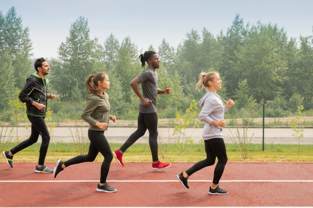 Group running on a track, symbolizing endurance and progress through threshold training.