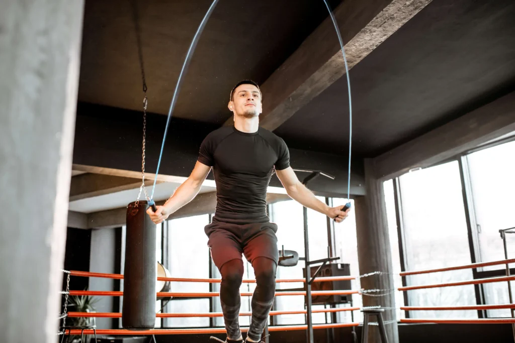 Man performing neuromuscular training with a jump rope, focusing on agility and coordination.