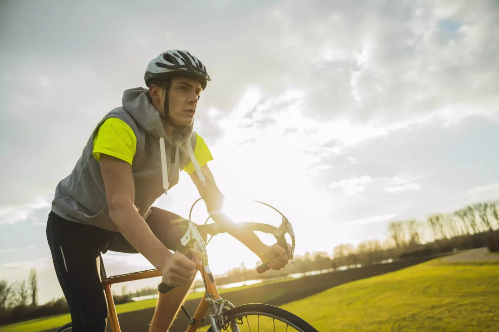 Young cyclist riding outdoors, focusing on maintaining a low variability index for improved endurance.